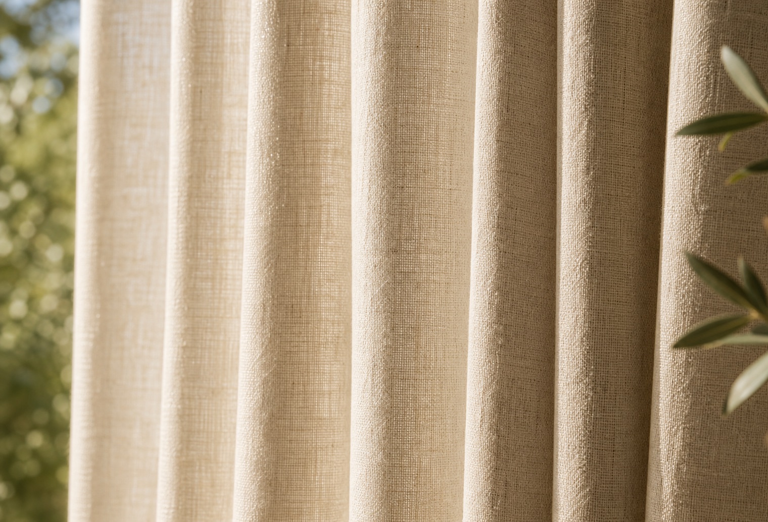 Close-up of ivory linen curtain folds in warm daylight